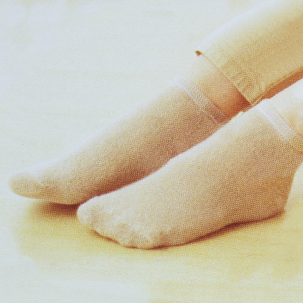 a pair of soft beige thermal socks being worn